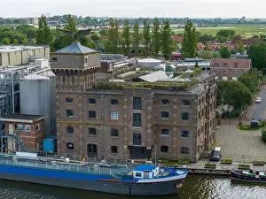 Cargo Ship Prints: Aerial drone photo of a cargo barge docked at an industrial zone in Wormerveer
