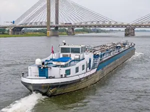 Cargo Ship Prints: Aerial drone photo of a cargo ship on the river Waal in the Netherlands