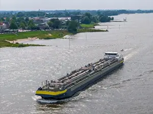 Cargo Ship Prints: Aerial drone photo of a cargo ship on the river Waal in the Netherlands