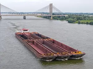 Cargo Ship Prints: Aerial drone photo of a large cargo barge sailing on the river Waal in the Netherlans