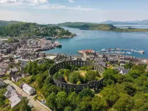 Oban Prints: An aerial drone photo of the Mccaig's tower in Oban with a beautiful view over town and the bay