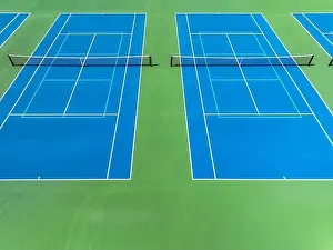 Aerial, drone, photo of new outdoor blue tennis court with white lines combined with light blue pickleball lines