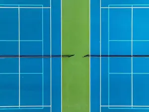 Aerial, drone, photo of new outdoor blue tennis court with white lines combined with light blue pickleball lines