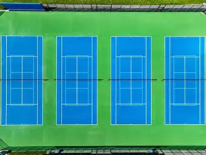 Aerial, drone, photo of new outdoor blue tennis court with white lines combined with light blue pickleball lines