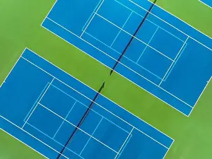 Retaining Prints: Aerial, drone, photo of new outdoor blue tennis court with white lines combined with light blue pickleball lines