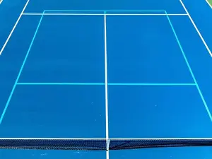 Aerial, drone, photo of new outdoor blue tennis court with white lines combined with light blue pickleball lines