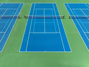 Retaining Prints: Aerial, drone, photo of new outdoor blue tennis court with white lines combined with light blue pickleball lines