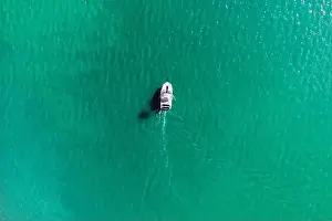 Water Sport Prints: Aerial drone photo of rib speed boat cruising in tropical exotic bay with emerald sea