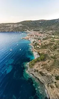 Aerial drone shot of Adriatic coastline dock by Komiza on Vis Island in morning before sunrise in Croatia summer