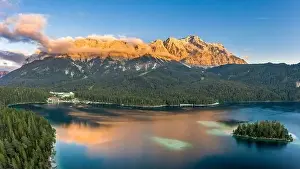 Garmisch Prints: Aerial drone shot of Alpenglow with fog on Zugspitze by Eibsee lake in Germany