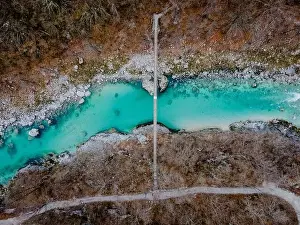 Julian Prints: Aerial drone shot of bridge over the beautiful crystal blue Soca River at the Kozjak fall in Slovenia