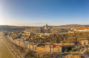 National Gallery Prints: Aerial drone shot of Buda Castle palace facade on hill in Budapest sunrise glow