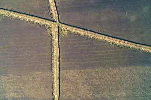 Obstacle Prints: Aerial drone shot of complex defensive trench fortifications with a zig-zag pattern built into farmland
