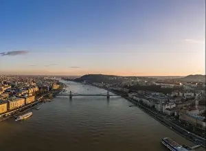 National Gallery Prints: Aerial drone shot of Danube river with chain bridge and Buda Castle in Budapest in Sunset hour
