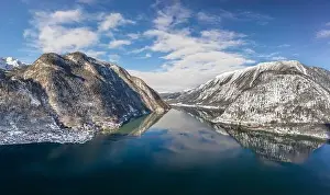 Northern Limestone Alps Prints: Aerial drone shot of ferry boat on Hallstatt lake with ripples i