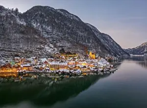 Northern Limestone Alps Prints: Aerial drone shot of Hallstatt village covered by snow during du