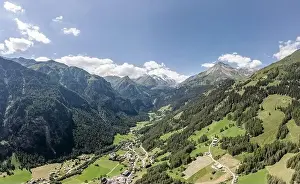 Hohe Tauern Prints: Aerial drone shot of Helligenblutt village in with view of Grossglockner mountain in Austria