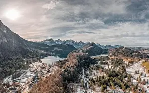 Snow Mountain Prints: Aerial drone shot of Hohenschwangau by lake in Fussen with view of Alps snow mountain range in Germany winter