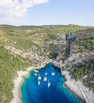 Covert Prints: Aerial drone shot of iconic Stiniva cove beach of Adriatic sea on Vis Island in Croatia summer