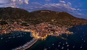 Adriatic Sea Prints: Aerial drone shot of Komiza town port in night with city light on Vis Island in Croatia summer dusk