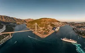 Dalmatian Coast Prints: Aerial drone shot of Lapad Gruz peninsula area with Dubrovnik bridge cruise ship in Croatia summer sunset