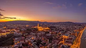 Beautiful Sky Prints: Aerial drone shot of lighted Matthias Churh Fisherman's Bastion on Buda Hill in Budapest sunset time