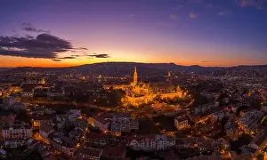 Beautiful Sky Prints: Aerial drone shot of lighted Matthias Churh Fisherman's Bastion on Buda Hill in Budapest sunset time