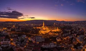 Beautiful Sky Prints: Aerial drone shot of lighted Matthias Churh Fisherman's Bastion on Buda Hill in Budapest sunset time