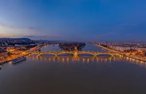 Buda Prints: Aerial drone shot of Margaret Bridge with lights on over Danube river during Budapest sunset