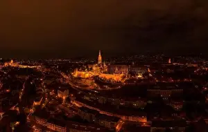 City Light Prints: Aerial drone shot of Matthias Church with lights on Buda Hill in Budapest evening