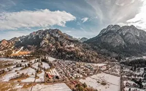 Fussen Prints: Aerial drone shot of picturesque Neuschwanstein Castle on snowy hill in winter sunlight in Germany