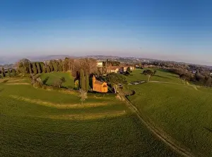 Brianza Prints: Aerial drone shot. Red church of Pomelasca at sunset - Lombardy countryside panorama
