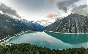 Aerial drone shot of Schlegeisspeicher resevoir with galcier view at dusk