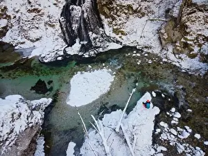 Forest Trees Prints: Aerial drone shot of snowy and icy winter landscape in the oetschergraeben