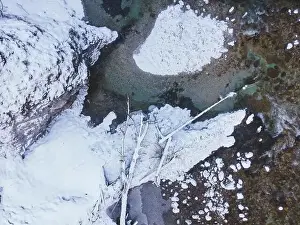 Aerial drone shot of snowy and icy winter landscape in the oetschergraeben