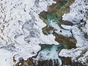 Forest Trees Prints: Aerial drone shot of snowy and icy winter landscape in the oetschergraeben