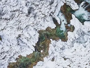 Forest Trees Prints: Aerial drone shot of snowy and icy winter landscape in the oetschergraeben