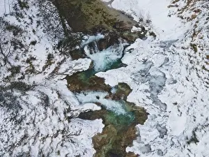 Forest Trees Prints: Aerial drone shot of snowy and icy winter landscape in the oetschergraeben