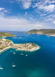 Riva Prints: Aerial drone shot of St. Jeronima church on Vis Island coastline by adriatic sea in summer