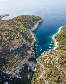 Covert Prints: Aerial drone shot of Stiniva cove beach of Adriatic sea on Vis Island in Croatia summer
