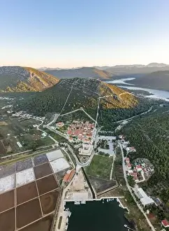 Salt Pan Prints: Aerial drone shot of Ston city wall over hill in Ragusa region near Dubrovnik in Croatia summer sunrise
