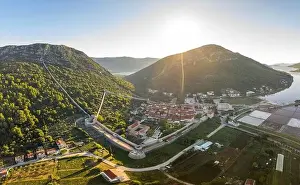 Ragusa Prints: Aerial drone shot of Ston city wall over hill in Ragusa region near Dubrovnik in Croatia summer sunrise