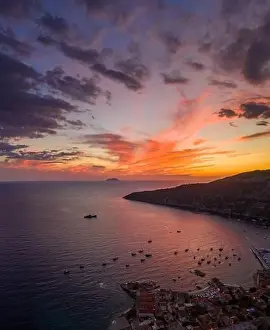 Burning Clouds Prints: Aerial drone shot of sunset burning sky clouds on Komiza town over Vis Island in Croatia Summer