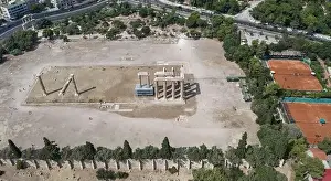 Gods View Prints: Aerial drone shot of temple ruins at Archaeological Site of Olympieion with tennis court biesdes