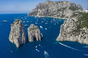 Sea Stacks Prints: Aerial drone shot view of faraglioni limestone crags in summer in Tyrrhenian sea with yachts off Capri Island