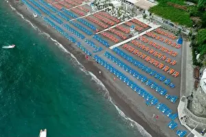 Amalfi Prints: Aerial drone shot view of Positano village and beach with beach umbrella in the morning in Amalfi Coast