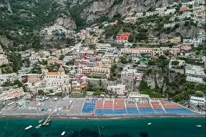 Amalfi Prints: Aerial drone shot view of Positano village and beach with parasols in the morning in Amalfi Coast