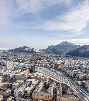 Salzach Prints: Aerial drone shot view of railway statioin in Salzburg covered with snow in winter morning