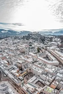 Salzach Prints: Aerial drone shot view of snowy salzburg city center with view of Cathdrals and fortress in winter