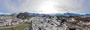 Salzach Prints: Aerial drone shot view of snowy salzburg city along river and mountain ridges in winter